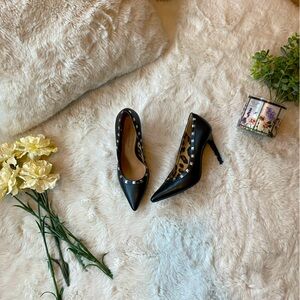 Black heels with silver studs and leopard print interior.